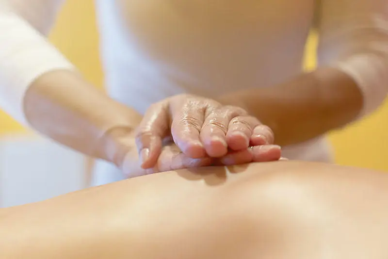 Hands performing osteopathy treatment